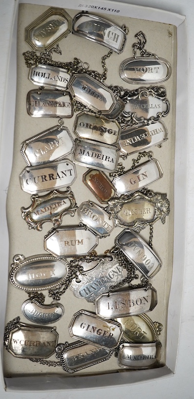 A collection of thirty two silver plated mostly named spirit labels, from the 19th century and 20th century, largest ‘Lisbon’ 6cm wide. Condition - a few where the plate has worn but most good